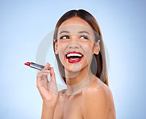 Beauty, red lipstick or makeup with woman thinking about face cosmetics in studio. Aesthetic female model on a blue