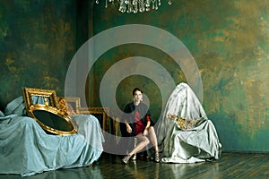 beauty rich brunette woman in luxury interior near empty frames,