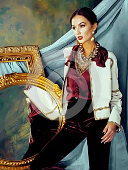 Beauty rich brunette woman in luxury interior near empty frames