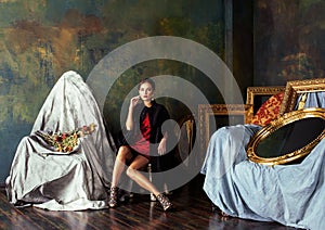 Beauty rich brunette woman in luxury interior near empty frames