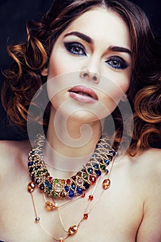 Beauty rich woman with bright makeup wearing luxury jewellery lo