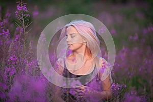 Beauty romantic girl outdoors. Beautiful teenage model with pink hair girl on the field of fireweed in sunrise