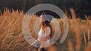 Beauty Romantic Girl Outdoors. Pretty Teenage Model girl enjoying nature. Girl the Field in Sun Light. Blowing Long Hair. Autumn.