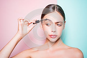 Beauty routine. Girl hold cosmetic applicator. Woman put makeup on her face. Daily makeup concept. Makeup and cosmetics