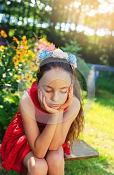 Beauty Sad Girl Outdoors dreaming at the garden. Beautiful Teenage girl with long hair smiling.