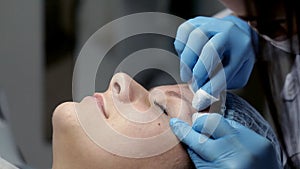 In the beauty salon the beautician makes the client a mechanical face cleaning