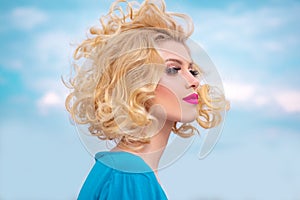Beauty Salon. Blond woman with curly beautiful hair. Beauty Model girl with Healthy Hair.