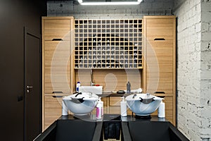 Beauty salon interior - hair washing sinks - white washbasins for hairdresser