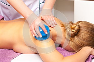 Beauty salon. Woman getting spa cupping glass vacuum massage photo