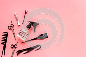 Beauty saloon accessories - combs, sciccors for hairdressing - on pink background top-down frame copy space