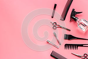 Beauty saloon accessories - combs, sciccors for hairdressing - on pink background top-down frame copy space