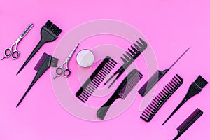 Beauty saloon equipment. Hairdress, haircut. Combs, sciccors, brushes on pink background top view copy space