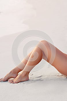 Beauty Sexy Suntan Bikin Woman Legs Relaxing Lying Down near Beach.  Beauty Skincare. Protection Sun.