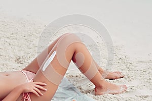 Beauty Sexy Suntan Bikin Woman Legs Relaxing Lying Down near Beach.  Beauty Skincare. Protection Sun.