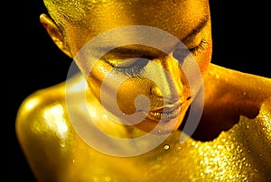 Beauty sexy woman with golden skin. Fashion art portrait closeup. Model girl with shiny golden professional makeup