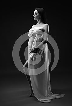 Beauty and sexy of young pregnant woman with white material - grey background