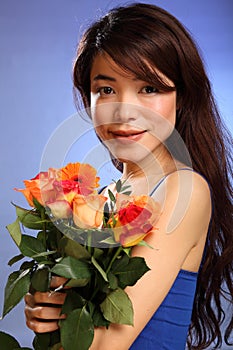 Beauty shot young Japanese girl holding flowers