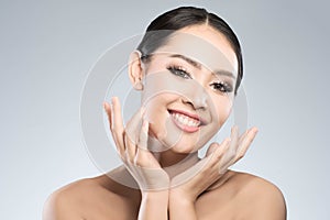 Beauty shot of young pretty asian woman with clear skin ongrey b