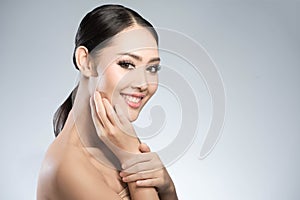 Beauty shot of young pretty asian woman with clear skin ongrey b