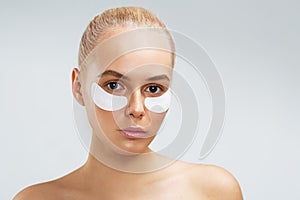 Beauty shot of a young woman with undereye mask photo