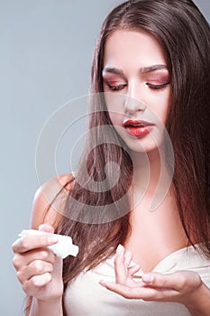 Beauty Skin Care. Beautiful Woman Applying Cosmetic Face Cream