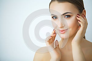 Beauty Skin Care. Beautiful Woman Applying Cosmetic Face Cream