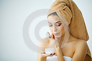 Beauty Skin Care. Beautiful Woman Applying Cosmetic Face Cream