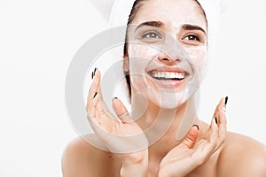 Beauty Skin Care Concept - Beautiful Caucasian Woman Face Portrait applying cream mask on her facial skin white