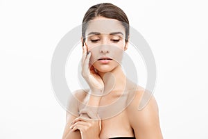 Beauty and Skin care concept - Close up Beautiful Young Woman touching her skin on white background.