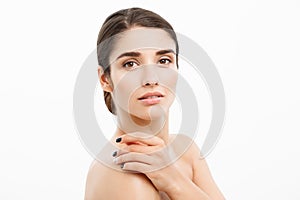 Beauty and Skin care concept - Close up Beautiful Young Woman touching her skin on white background.