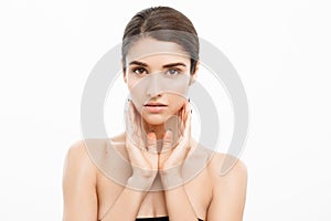 Beauty and Skin care concept - Close up Beautiful Young Woman touching her skin on white background.