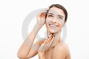 Beauty and Skin care concept - Close up Beautiful Young Woman touching her skin on white background.