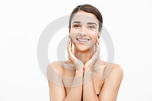 Beauty and Skin care concept - Close up Beautiful Young Woman touching her skin on white background.