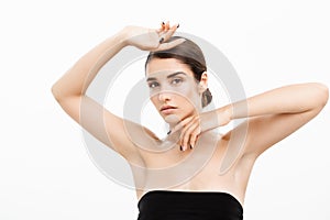 Beauty and Skin care concept - Close up Beautiful Young Woman touching her skin on white background.