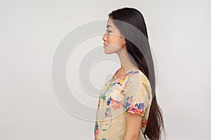 Beauty and skin care. Side view of attractive asian girl with beautiful long brunette hair in blouse looking at copy space