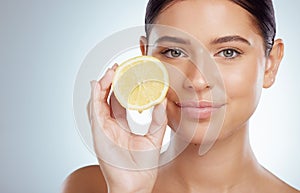 Beauty skincare, face and woman with lemon in studio isolated on a white background. Portrait, natural or female model