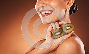 Beauty, skincare and kiwi with a model woman in studio on a brown background for natural treatment or nutrition. Spa