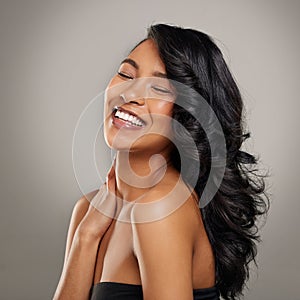 Beauty, skincare and smile with face of woman in studio on gray background for aesthetic or wellness. Eyes closed, face