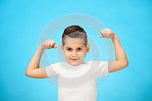 Beauty smiling sport child boy showing his biceps