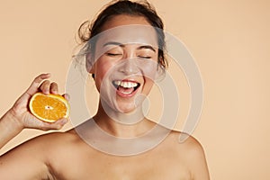 Beauty. Smiling woman with radiant face skin and orange portrait