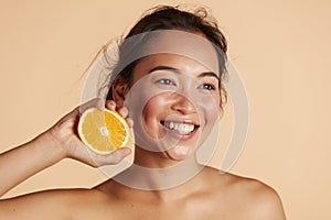 Beauty. Smiling woman with radiant face skin and orange portrait