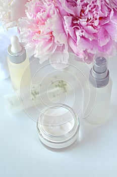 Beauty Spa cosmetics with pink peonies and luxury creams