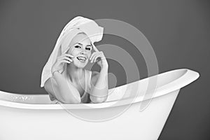 Beauty and spa, girl with towel turban in white bathtub