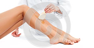 Beauty Spa. Hair removal cosmetology procedure. Beautician waxing female legs