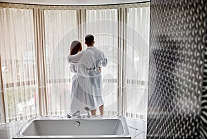 Beauty, spa, healthy lifestyle concept. Beautiful young couple in bathrobes relaxing at luxury hotel room