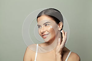 Beauty spa woman with perfect skin and creame on her cheek