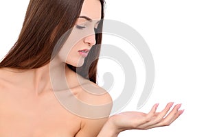 Beauty Spa Woman with perfect skin Portrait. Beautiful Brunette Spa Girl showing empty copy space on the open hand palm