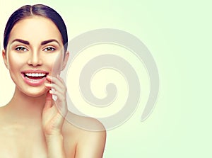 Beauty spa woman touching her face and smiling. Teeth whitening