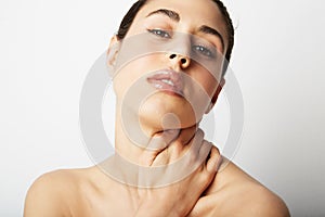 Beauty spa young woman portrait. Beautiful girl touching her face and neck. Skin treatment concept.