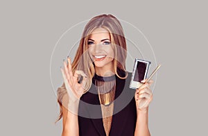 Beauty specialist with instruments holding okay sign